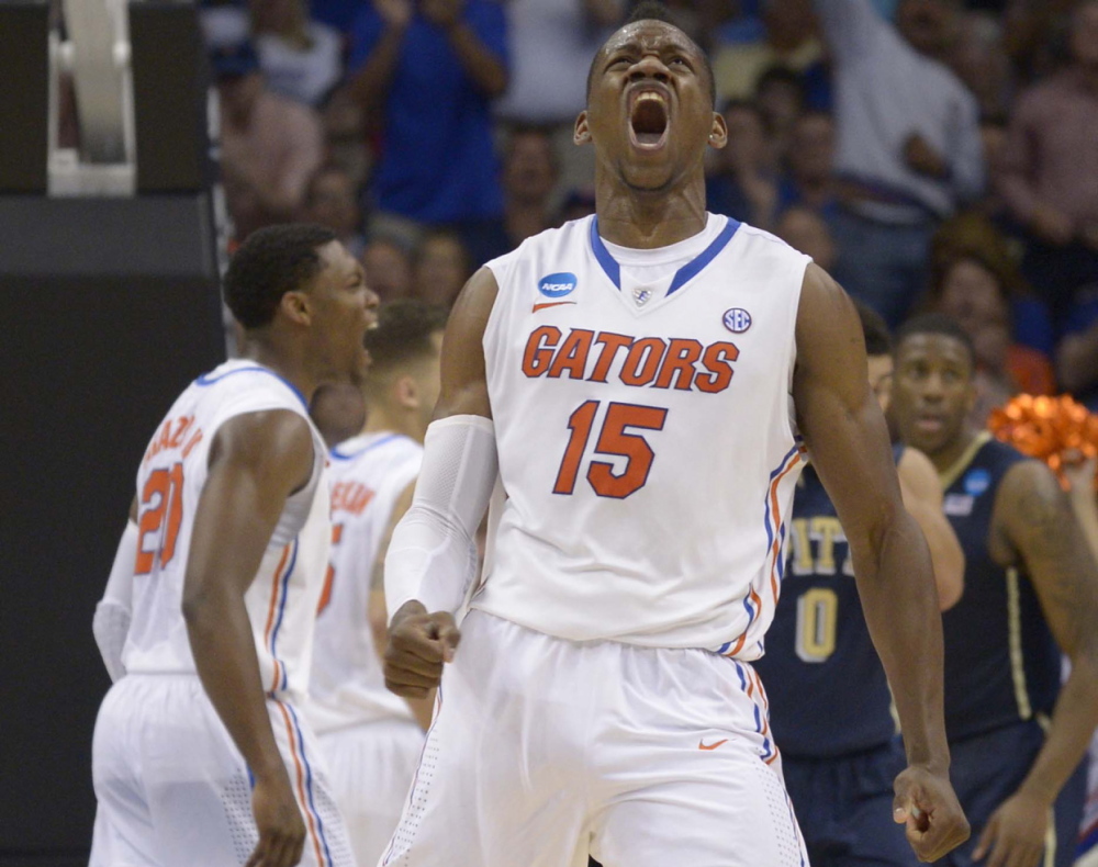 Florida forward Will Yeguete yells after scoring against Pittsburgh, during the second half of Saturday’s third-round game in the NCAA tournament Saturday Orlando, Fla. The top-seeded Gators won, 61-45.