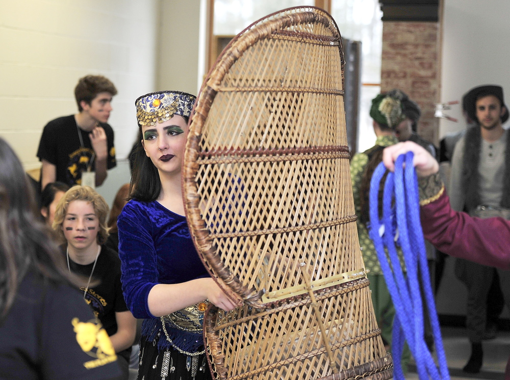 Senior Amelia French, who adapted Rudyard Kipling’s “Just So Stories” into a one-act play, carries a prop Saturday at the state drama festival in Yarmouth.
