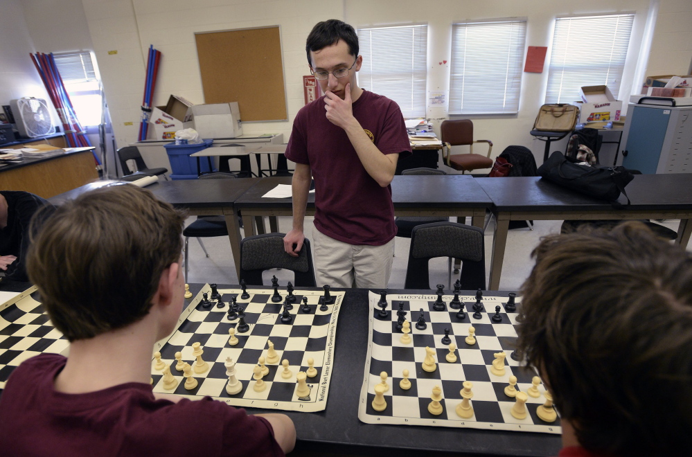 Matthew Fishbein, a sophomore at Cape Elizabeth, contemplates his next move while playing a chess match against two of his teammates at the same time on March 17, 2014.