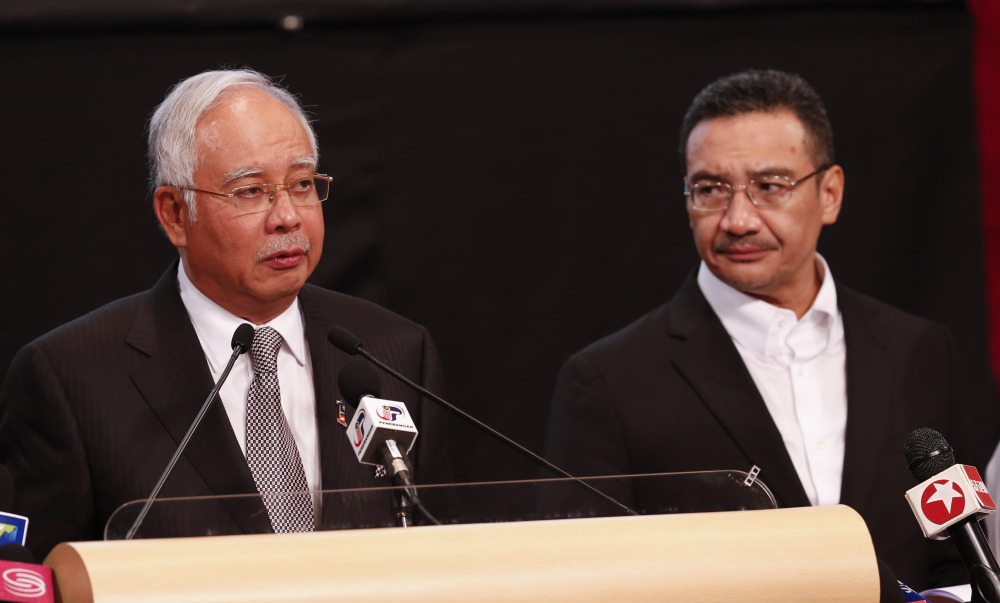 Malaysia’s Prime Minister Najib Razak, left, and acting transport minister Hishammuddin Hussein speak during a press conference for the missing Malaysia Airlines jet in Kuala Lumpur, Malaysia, Monday.