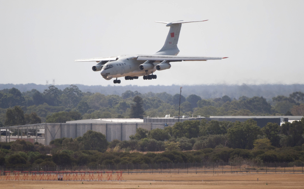 A Chinese IL-76 plane searching for the missing Malaysia Airlines Flight MH370 returns to Perth airport, Australia, after a sortie on Monday. A Chinese plane on Monday spotted two white, square-shaped objects in an area identified by satellite imagery as containing possible debris from the missing Malaysian airliner, while the United States separately prepared to send a specialized device that can locate black boxes.