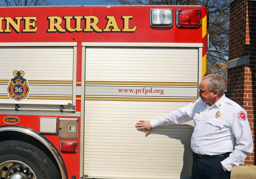 Fire Chief Hank Clemmensen of Palatine, Ill., shows where ads will appear on the sides of firetrucks.
