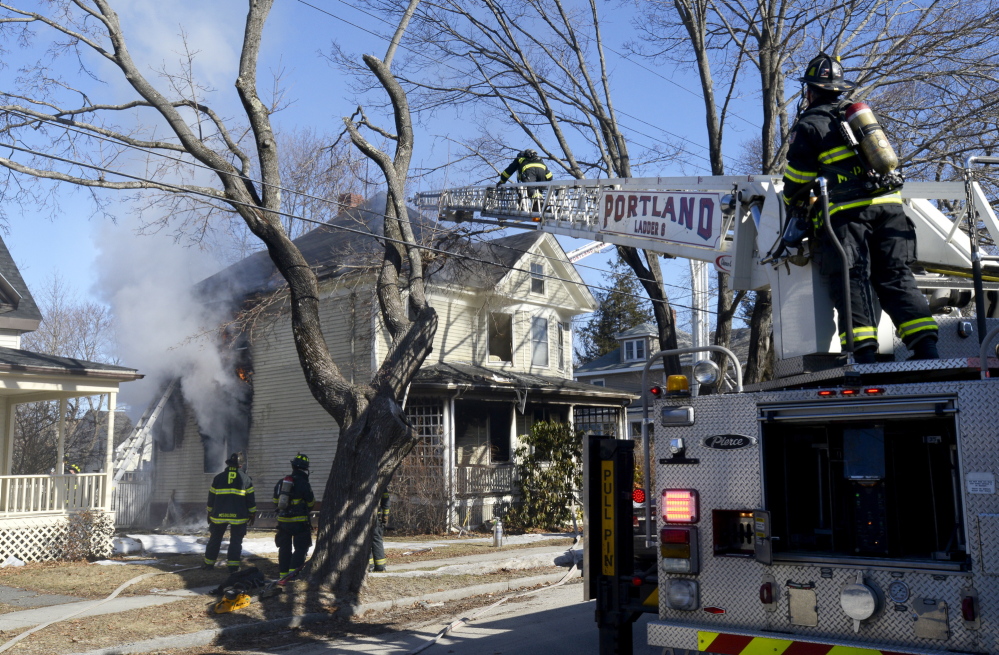 Portland firefighters battle a house fire at 38 Columbia Road in Portland on Monday.