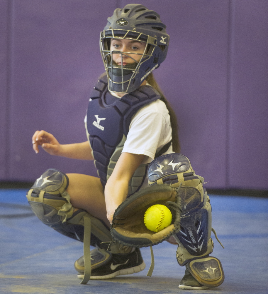 Cheverus junior Margaret Rigney gloves a pitch during the softball team’s first day of preseason practice on Monday. Rigney is expected to be the team’s regular catcher this season.