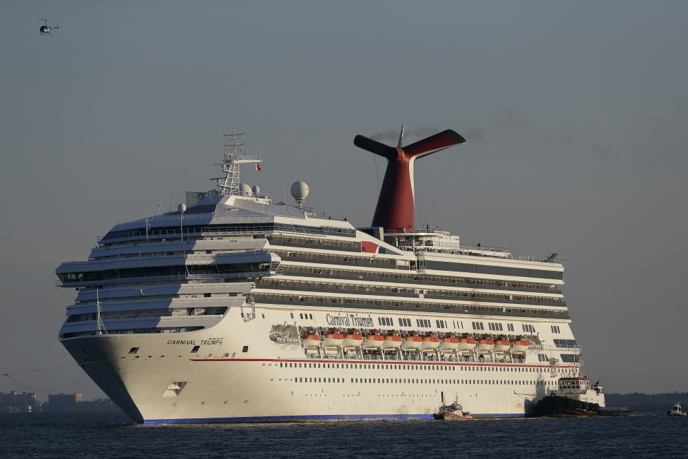 The cruise ship Carnival Triumph is towed into Mobile Bay, Ala., on Feb. 14, 2013. The ship was adrift for days in the Gulf of Mexico, subjecting some 3,000 passengers to squalid conditions.