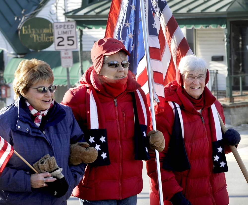 Josephine Holley, left, of South Freeport, was among the dozens of supporters who showed up to support Elaine Greene and JoAnn Miller, two of the original flag ladies, who continued their weekly vigil in downtown Freeport.