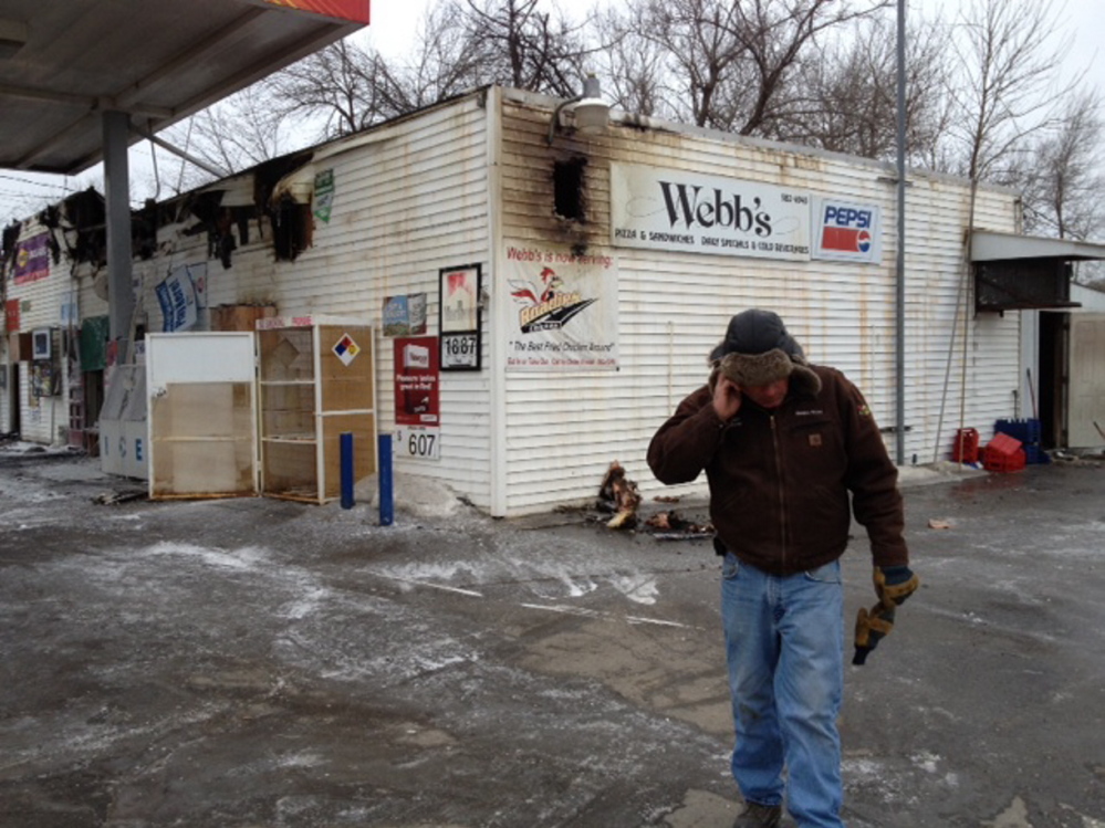 Staff photo by Andy Molloy Webb’s Store owner Dan Kilmer speaks on the phone Wednesday morning after a fire destroyed the business overnight.