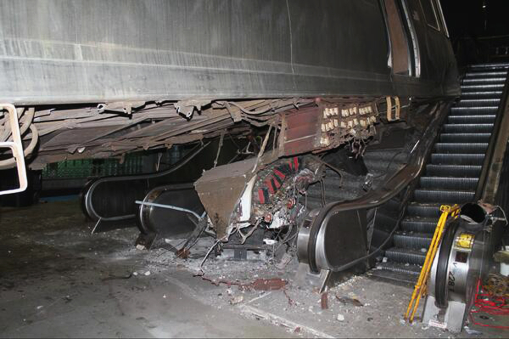 This photo released Tuesday, March 25, 2014, by the National Transportation Safety Board shows the aftermath of a Chicago commuter train that crashed Monday at O’Hare International Airport when the train jumped off the tracks and climbed an escalator. An NTSB official said Wednesday that the operator of the train admitted she “dozed off” before the accident.