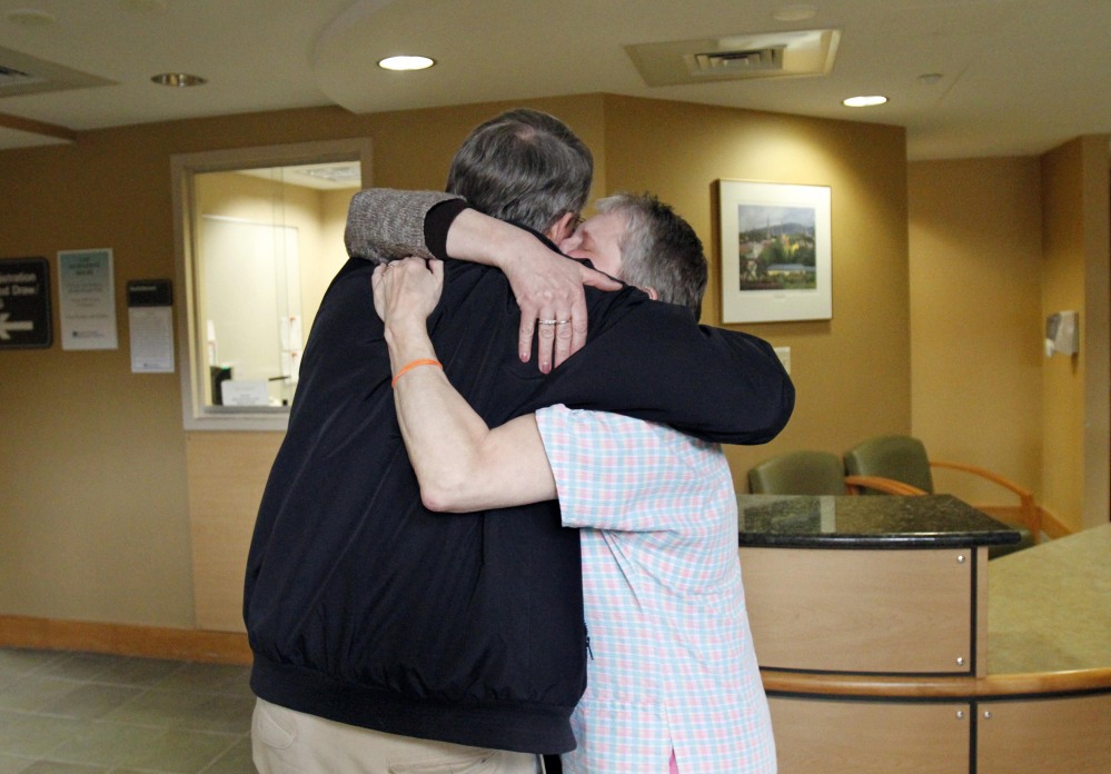 Nurse Debbie Little, right, and retired internist Erwin Steubner hug after the unexpected announcement Tuesday of the closure of the North Adams Regional Hospital.