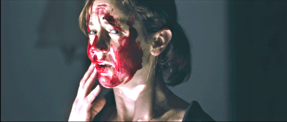 Casey Turner is bloodied in a scene from “The Hanover House.”