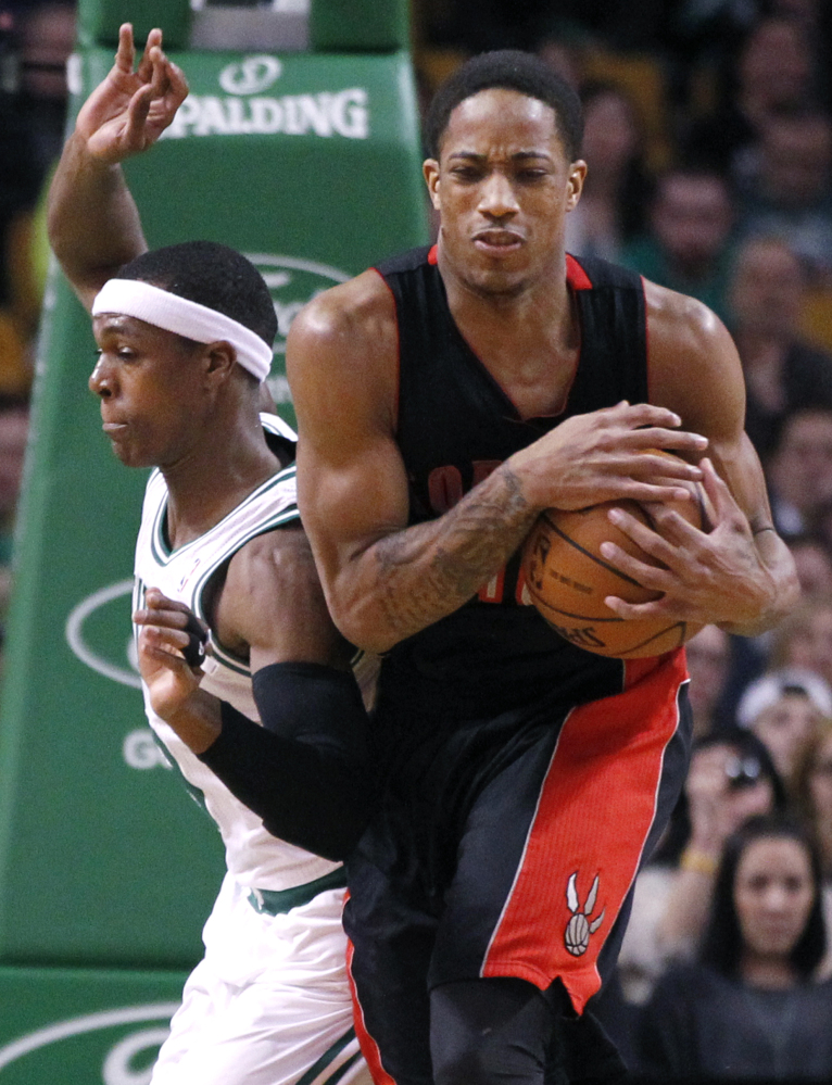 DeMar DeRozan of the Toronto Raptors, right, controls a rebound against Rajon Rondo of the Boston Celtics during Toronto’s 99-90 victory on the road Wednesday night.
