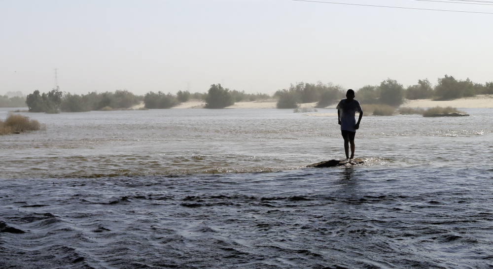 A man crosses the water Wednesday in what has been for decades a dry riverbed in San Luis Rio Colorado, Mexico. Seven U.S. and two Mexican states rely on the Colorado River.