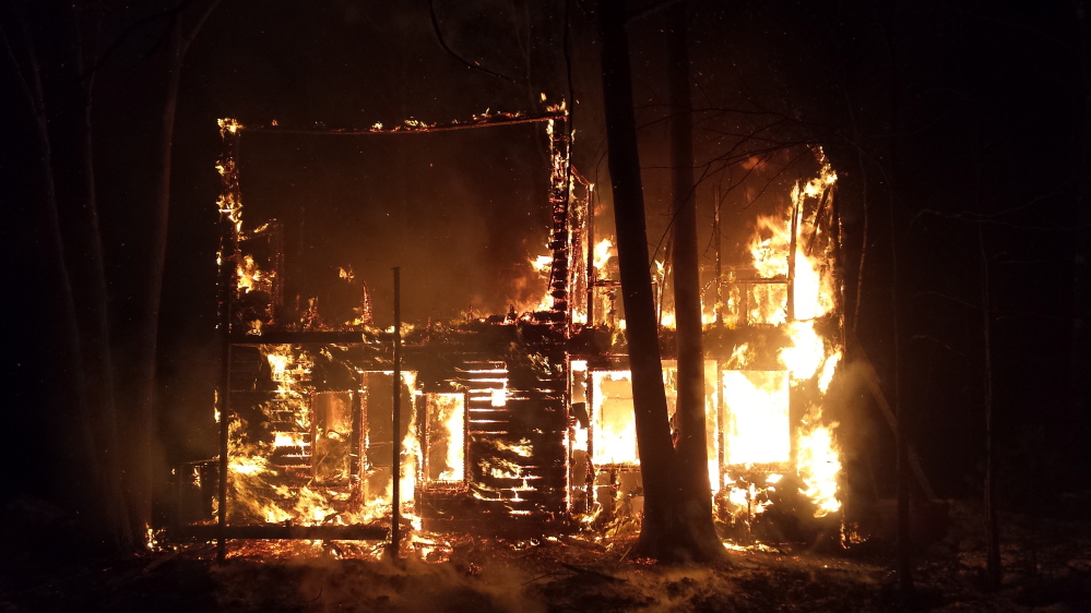 Fire engulfs a house on Lovers Lane in New Gloucester early Thursday morning. Emergency personnel from six towns were involved in battling the blaze.