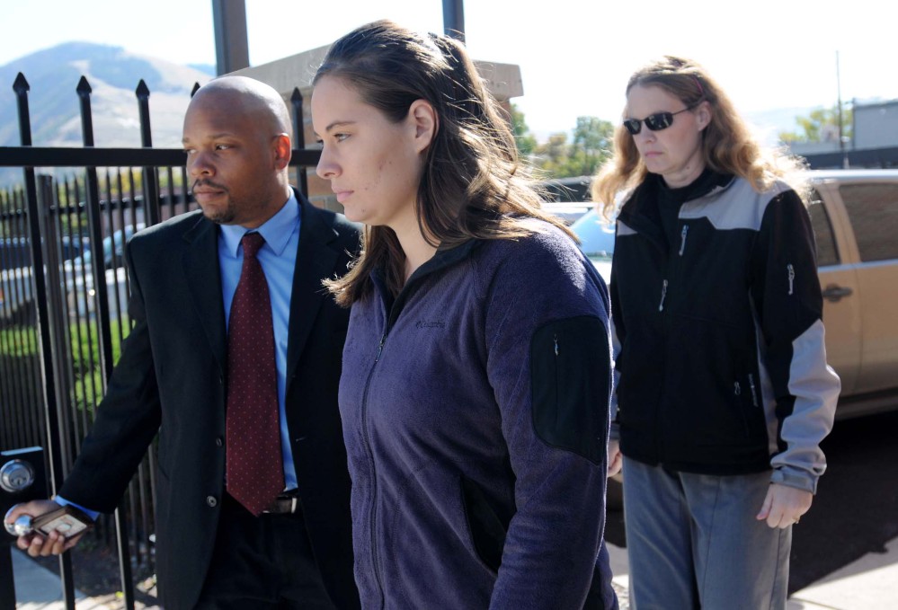 In this October 2013 file photo, Jordan Linn Graham, center, leaves the federal courthouse in Missoula, Mont.