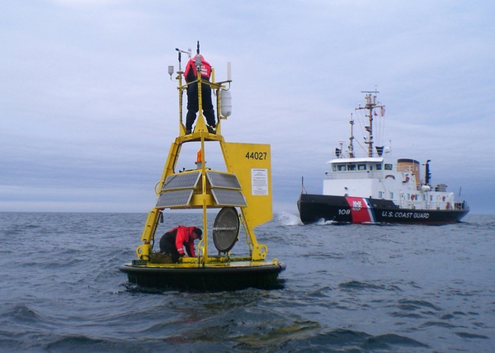 Workers maintain NOAA’s Jonesport buoy in this photo from the National Data Buoy Center website.