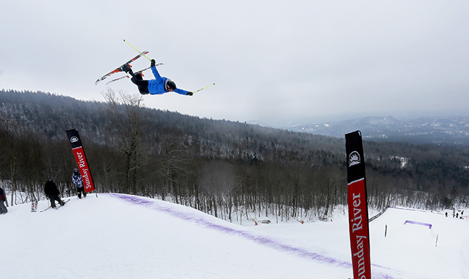 A skier extends all four limbs while clearing one of the big jumps at Sunday River. The Dumont Cup continues Saturday.