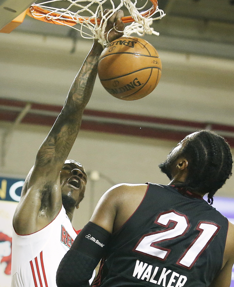 Frank Gaines of the Maine Red Claws slams the ball in front of Henry Walker of the Sioux Falls Skyforce during Sioux Falls’ 104-94 victory Friday night at the Portland Expo.
