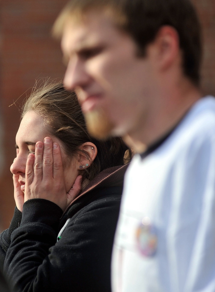 Trista Reynolds, back, and Justin DiPietro speak to the news media in January 2012 during a vigil in Waterville to call attention to their missing toddler, Ayla Reynolds.