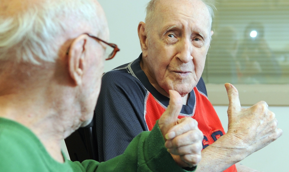 Twin brothers Lawrence Binette, left, and Maurice Binette give each other a thumbs-up on Thursday at an early 100th birthday party at the Maine Veterans’ Home in Augusta. They were born April 5, 1914, in Augusta .
