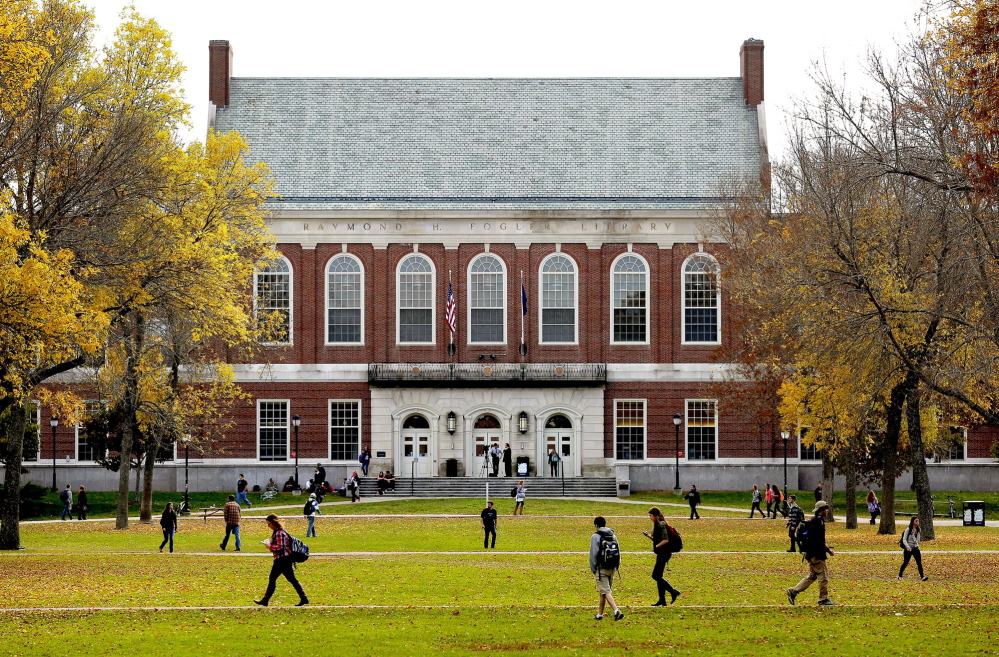 Students and faculty move through the mall at the University of Maine on a fall afternoon.