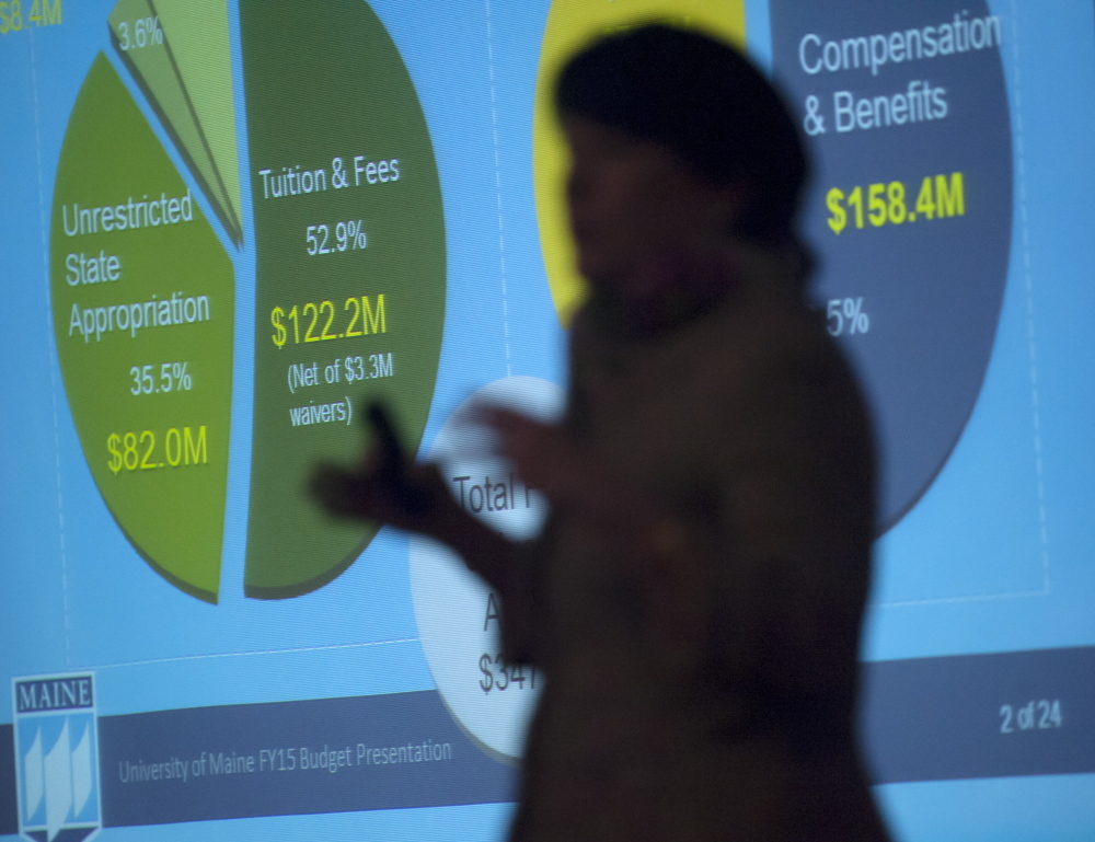 Janet Waldron, University of Maine’s senior vice president for administration and finance, is silhouetted in front of an overhead display during a budget presentation in Orono on Friday.
