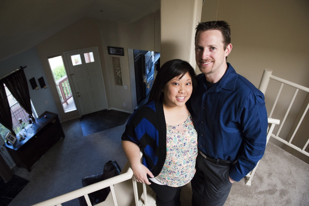 Jenny and Tim Haagen stand in their Tustin, Calif., condo, which they bought a little more than a year ago. In May 2010, the Haagens lost their jobs and moved in with Jenny's parents until they were re-employed and were able to purchase their new home.