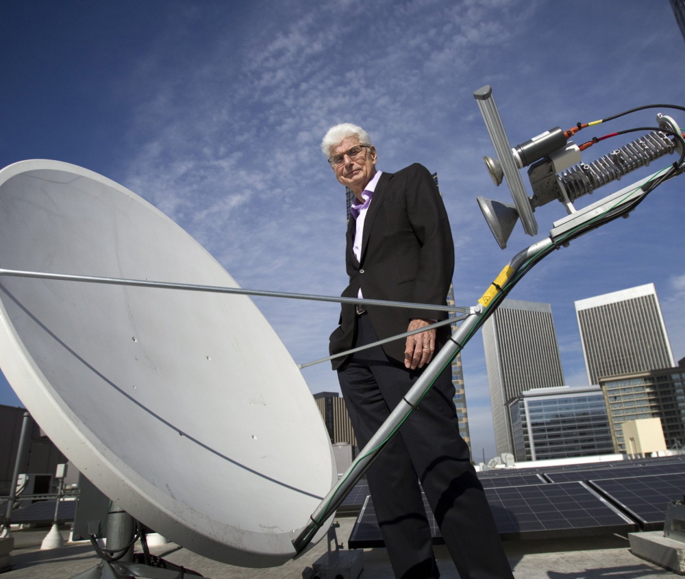 Randy Blotky, CEO of the Digital Cinema Distribution Coalition, stands by a satellite dish on the roof at the AMC Century City 15 theater in Los Angeles.
