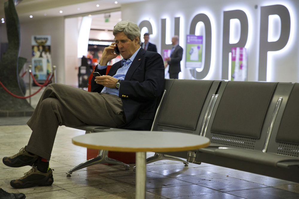 U.S. Secretary of State John Kerry speaks on his phone at Shannon Airport in Ireland on Saturday during a refueling stop. Halfway home from Saudi Arabia, Kerry has abruptly changed course and will stay in Europe for talks on the Ukraine crisis.