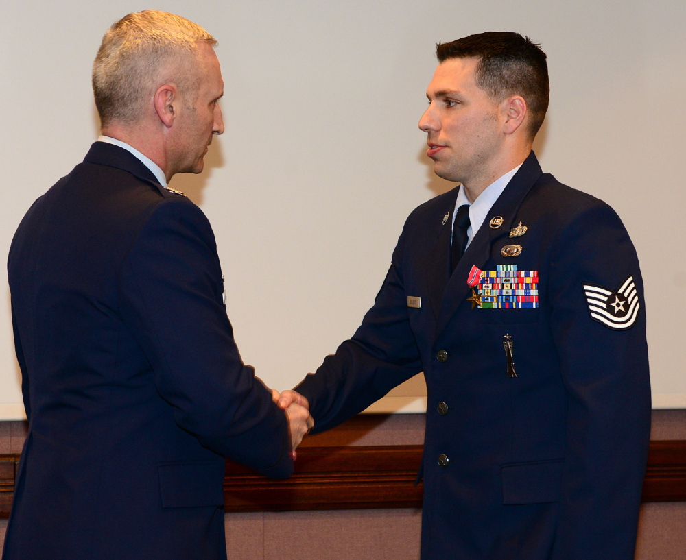 Air Force Sgt. Matt Bolduc of Oakland, right, shakes hands with Air Force Col. Jeff Hurlbert earlier this month.