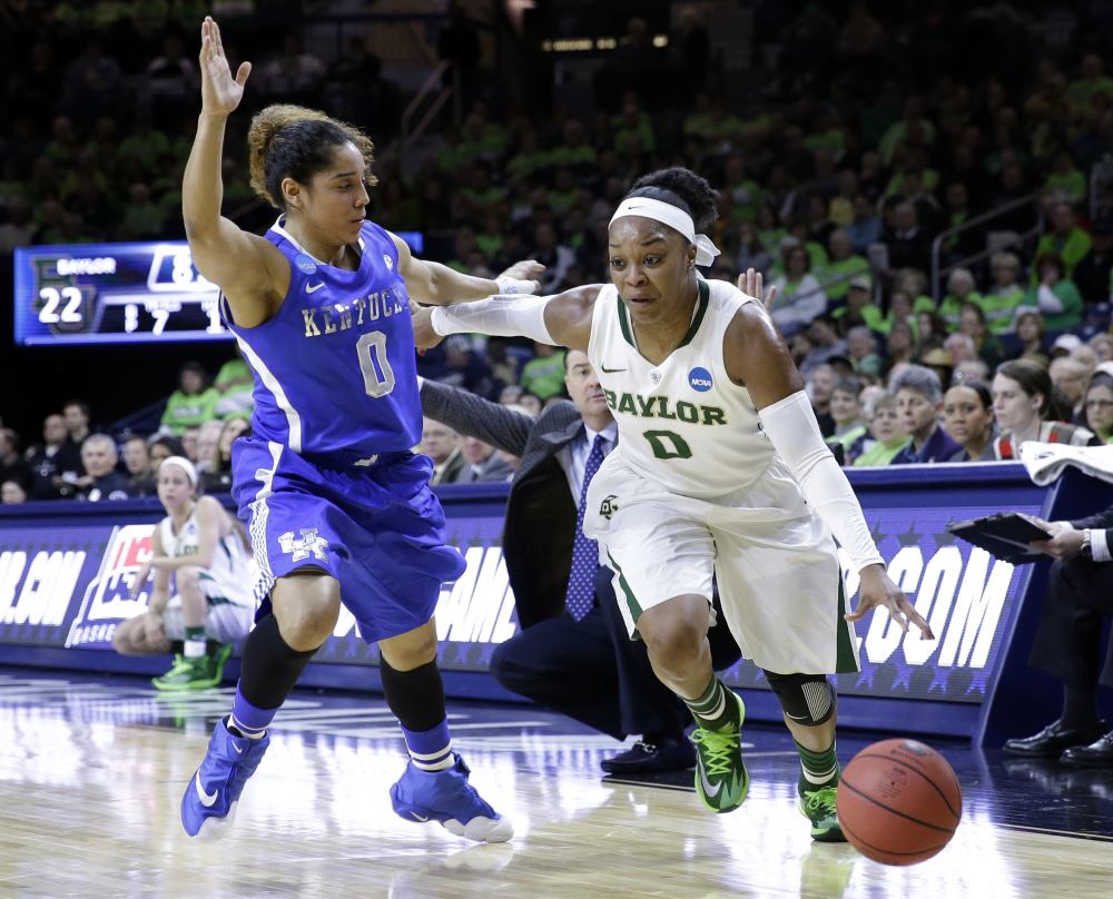 Baylor guard Odyssey Sims, right, drives to the basket against Kentucky guard Jennifer O’Neil in the NCAA tournament at South Bend, Ind.