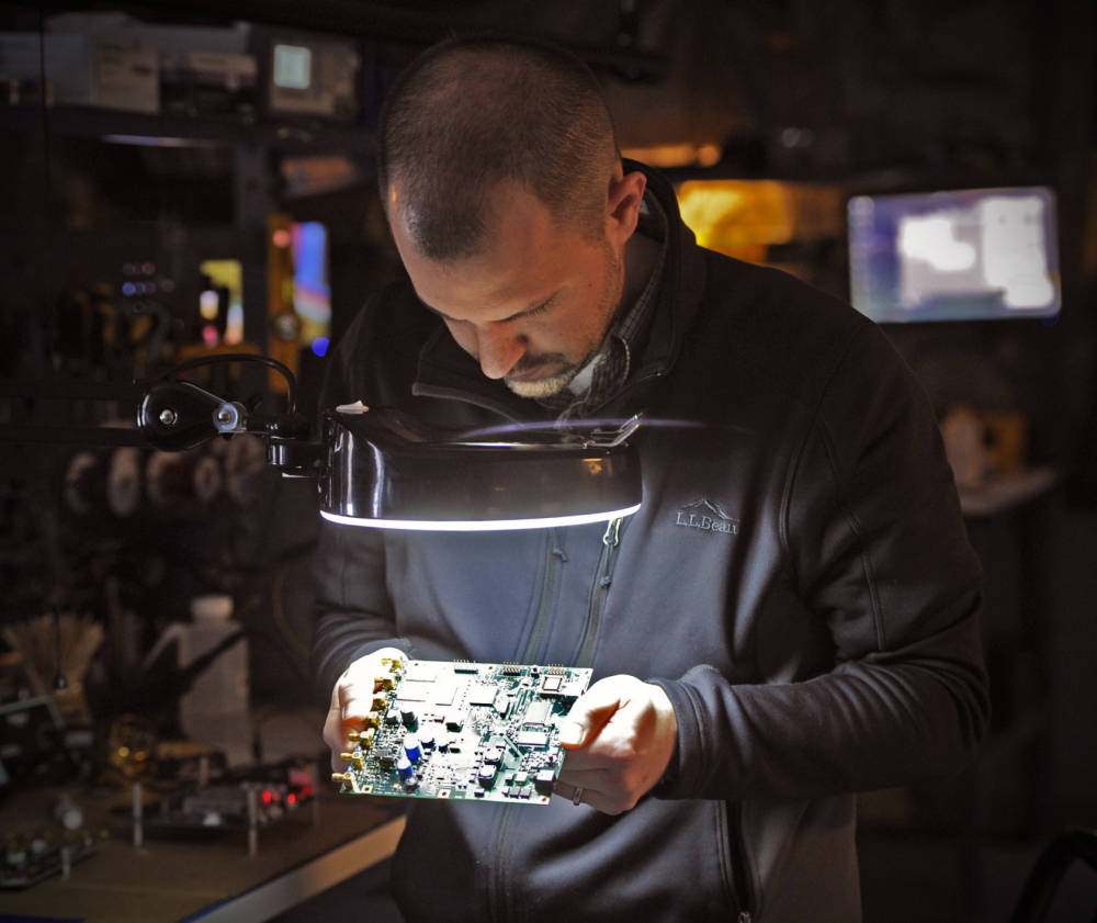 Electronics technician Tom Parker conducts a test on a control board at Fluid Imaging Technologies in Scarborough.
