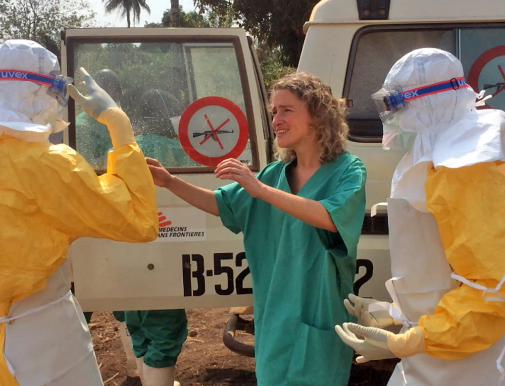 Health care workers prepare areas for their Ebola operations Friday in Gueckedou, Guinea. The outbreak has killed at least 70 people in the tiny West African country.
