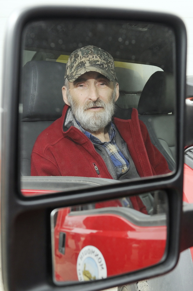 Leonard Crocker, sitting in a Monmouth Public Works truck on Friday at the town garage, says he would like to find the woman who apparently helped save his life March 17 in Monmouth after he had a heart attack and collapsed on a road while working.