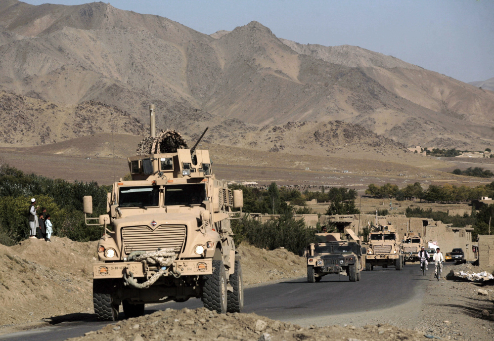 A column of U.S. Army Mine Resistant Ambush Protected armored vehicles – MRAPs – and Afghan National Army vehicles pass through a village during a joint patrol in the Jalrez Valley in Afghanistan’s Wardak Province in this 2009 file photo.
