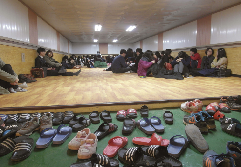 Residents and students of Yeonpyeong Island, South Korea, evacuate to a shelter on the island near the West Sea border with North Korea on Monday.