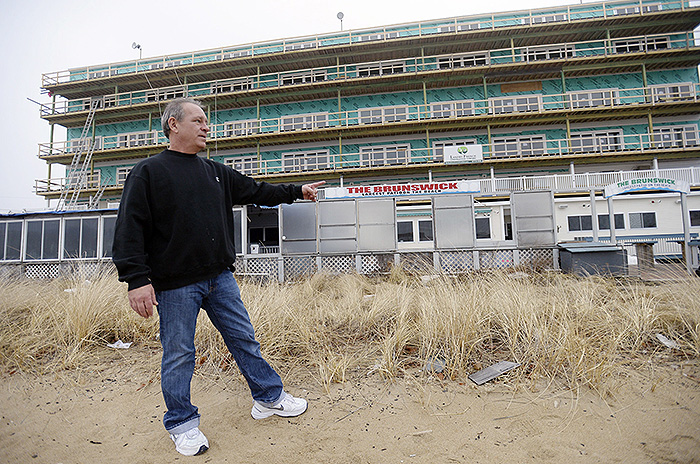 In this January 2014 file photo, Tom Lacasse, manager of the bar, restaurant and patio at the Brunswick in Old Orchard Beach, stands outside the waterfront business. He worries that new flood maps could hurt the business by causing a steep increase in flood insurance premiums.