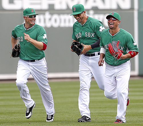 Exuberant and confident after last year’s success, outfielders Daniel Nava, Grady Sizemore and Shane Victorino share a laugh while returning to the dugout during a St. Patrick’s Day match-up against the St. Louis Cardinals.