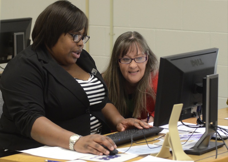 Quetta Pipkin, left, of the Medical Foundation of Chattanooga, assists Paige Carlton during an Affordable Care Act health care enrollment event at Cleveland State Community College, Wednesday, March 26, 2014, in Cleveland, Tenn.