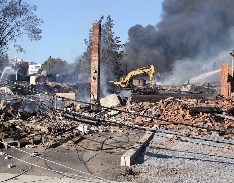 This July 2013 file photo provided by Surete du Quebec shows smoldering debris from a runaway train in Lac-Megantic, Quebec, Canada. Parties who believe they have a right to any proceeds from the liquidation of the bankrupt Montreal, Maine & Atlantic Railway have until mid-June to file claims. MM&A filed for bankruptcy right after the deadly Quebec disaster.