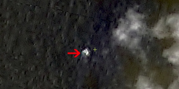 In this March 9, 2014 satellite image seen on the website of the Chinese State Administration of Science, Technology and Industry for National Defense, floating objects are seen at sea next to the red arrow which was added by the source. China's Xinhua News Agency reported Wednesday that the images show suspected debris from the missing Malaysia Airlines jetliner floating off the southern tip of Vietnam.