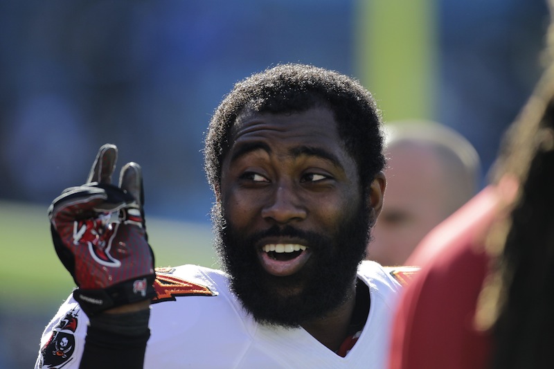 Former Tampa Bay Buccaneer Darrelle Revis clowns around with teammates during warm-ups before an NFL game in 2013. The Patriots have signed Revis to a one-year, $12 million deal.