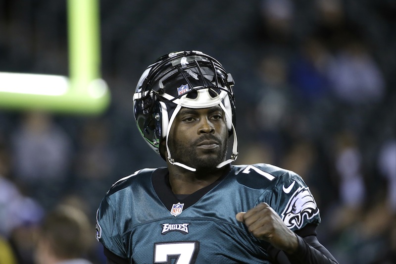 In a Dec. 22, 2013 file photo, Philadelphia Eagles' Michael Vick warms up before the first half of an NFL football game between the Philadelphia Eagles and the Chicago Bears, in Philadelphia. The New York Jets signed quarterback Michael Vick and released Mark Sanchez on Friday, March 21, 2014. Vick was a free agent after spending the last five seasons with the Phialdelphia Eagles.
