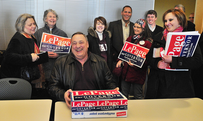 Gov. Paul LePage laughs with supporters as he delivers a box of petitions to get his name on the November ballot, at the Secretary of State's office Friday in the Cross State Office Building in Augusta.