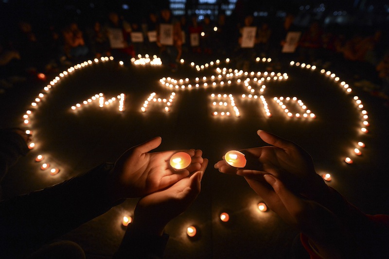 University students in Yangzhou, in eastern China's Jiangsu province, hold a candlelight vigil on March 13 for passengers on the missing Malaysia Airlines Flight MH370.