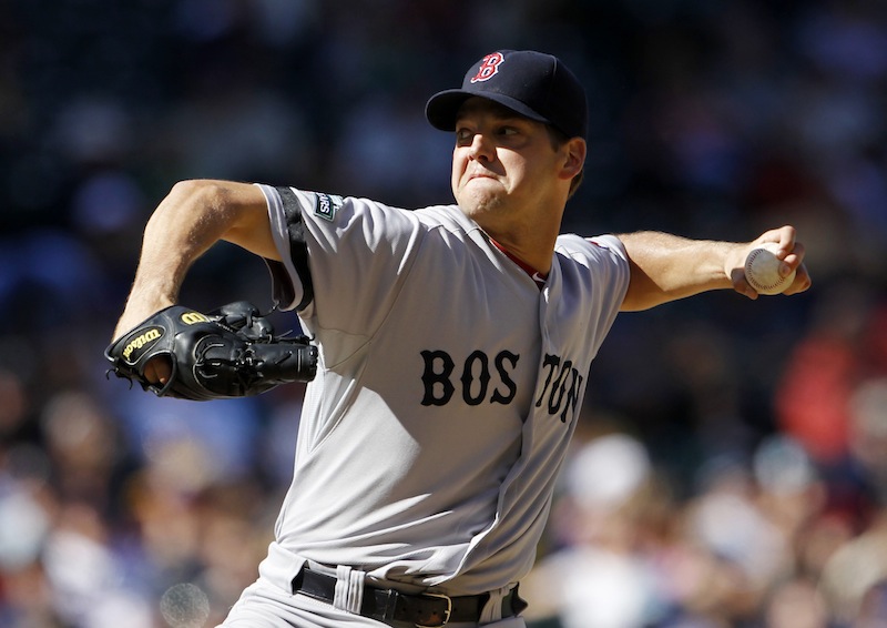 Boston Red Sox pitcher Rich Hill throws against the Seattle Mariners in Seattle in September 2012. Hill reported to Boston's camp Thursday, following the Feb. 24 death of his son Brooks, who was less than 2 months old.