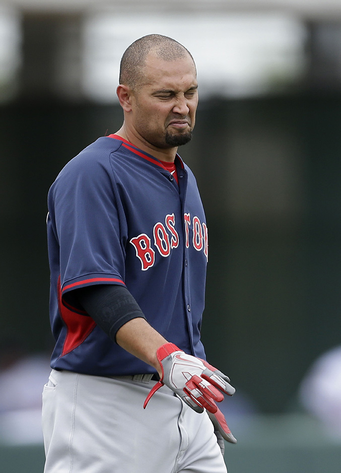 Boston Red Sox right fielder Shane Victorino, walks on the field between innings during an exhibition baseball game against the Minnesota Twins in Fort Myers, Fla., Friday, March 28.