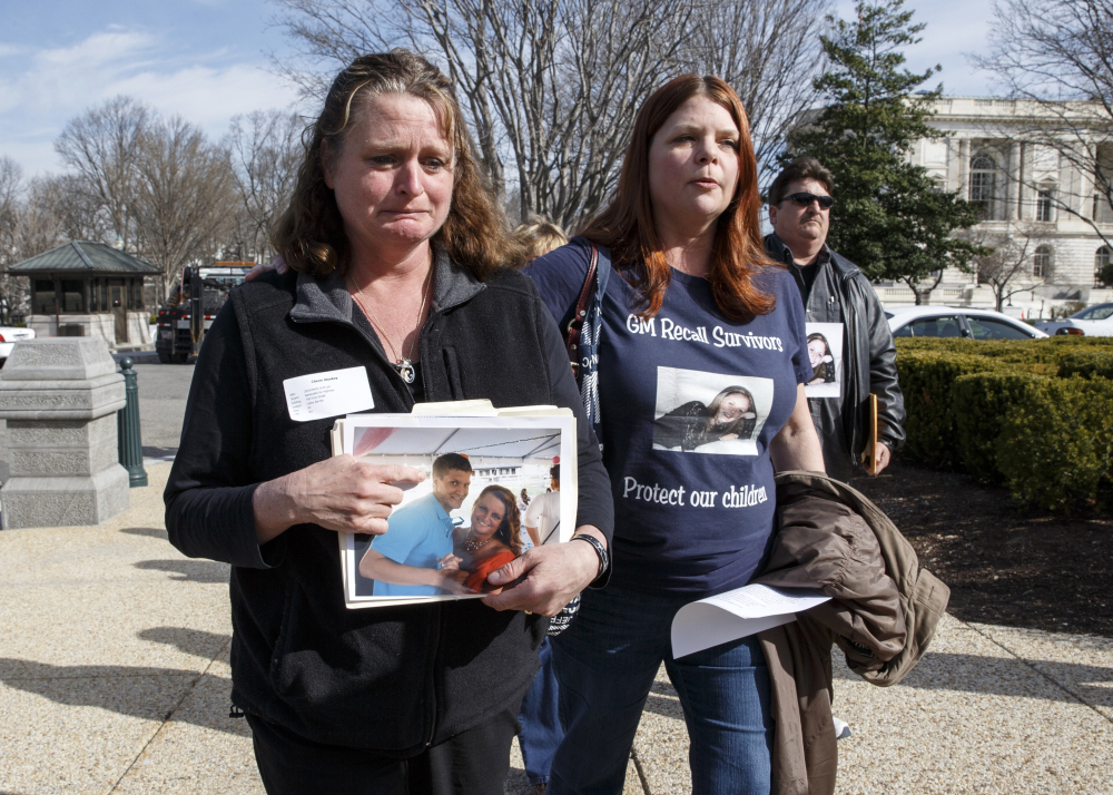 Cherie Sharkey, left, weeps for her son Michael Sharkey who died in his used 2006 Chevy Cobalt in Dresden, N.Y., as she walks with Laura Christian, of Harwood, Md., birth mother of Amber Marie Rose, the first reported victim of the General Motors safety defect, on Capitol Hill Tuesday.