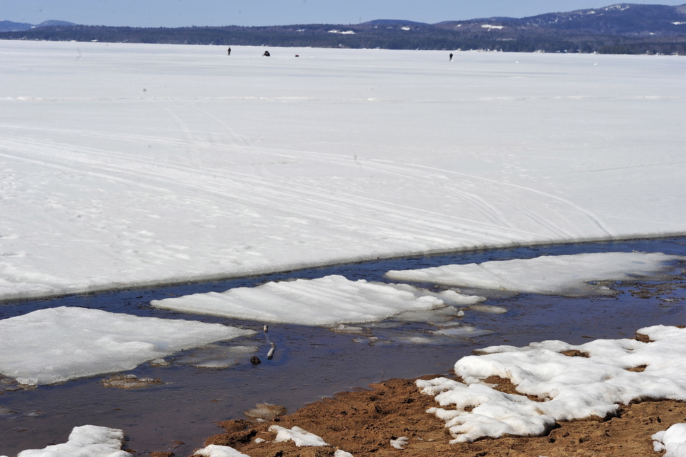 The ice continues to melt along the shore of Sebago Lake, making it harder for ice fishermen to get off the ice to shore.