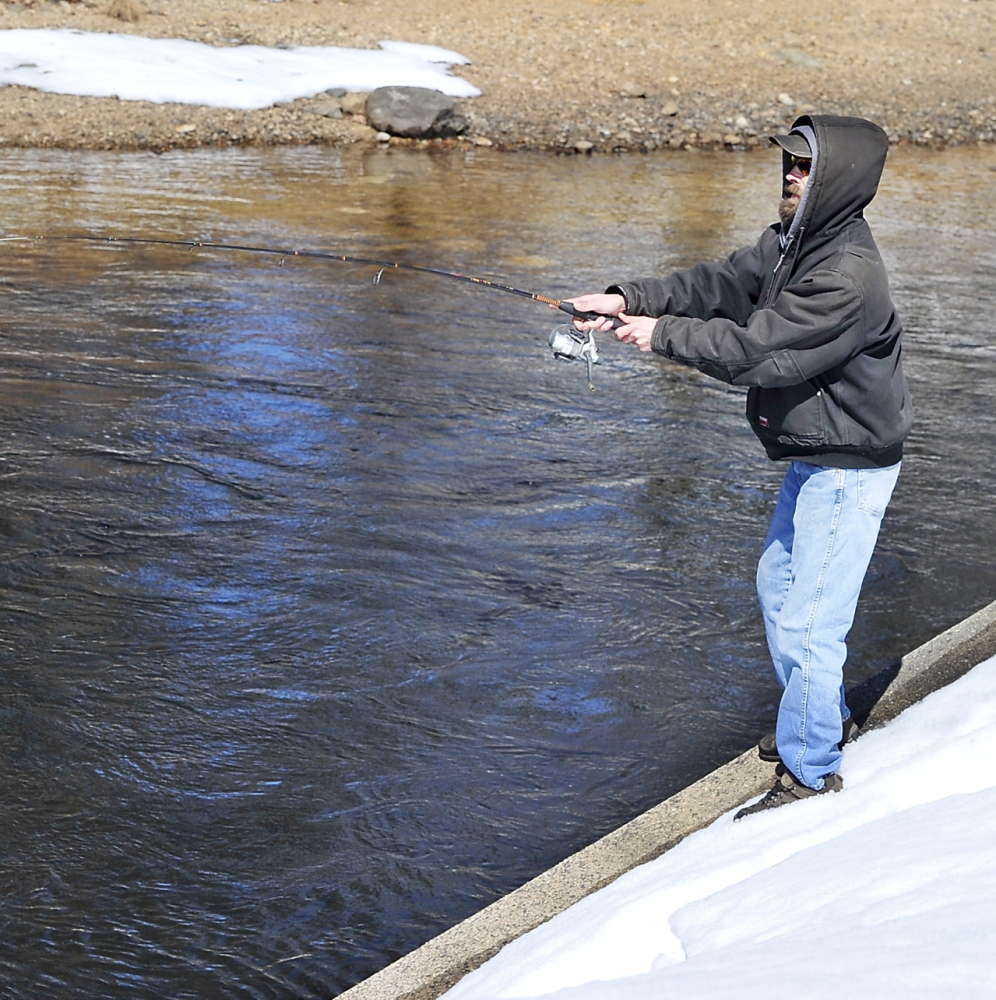 Ed Merrill of Naples casts at Songo Locks on Sebago Lake on the traditional first day of open-water fishing season.