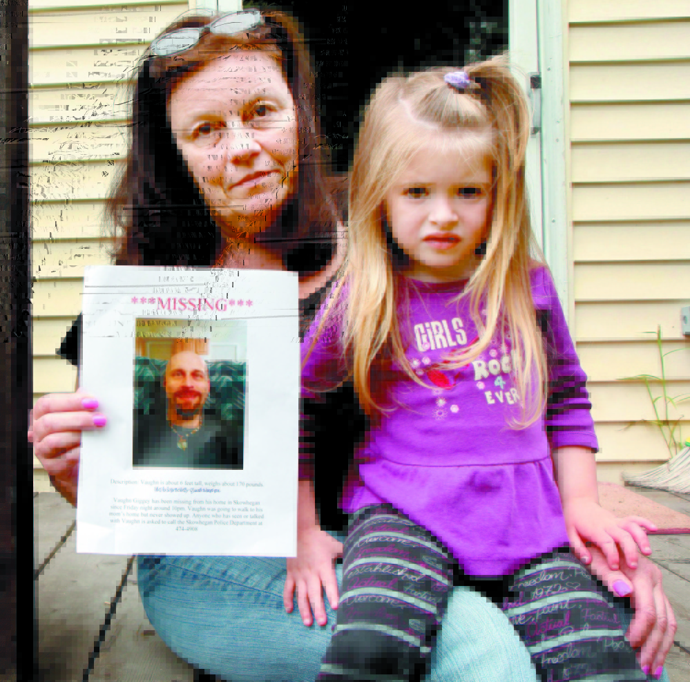 Rosanne Dubay, mother of Vaughn Giggey, displays a photo of him after he disappeared in August while walking from his Skowhegan home to hers. With her is Giggey’s niece, Arrienna Bowring. His body was found later in Currier Brook about a quarter-mile from his home on Main Street.